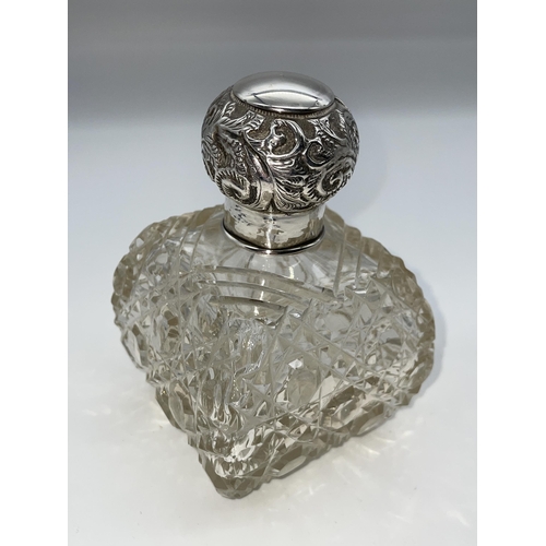 513 - SILVER TOPPED GLOBULAR SCENT BOTTLE AND A SILVER REPOUSE TOPPED BOMBE SHAPED HOBNAIL SCENT BOTTLE