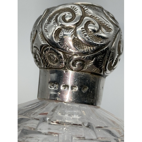 513 - SILVER TOPPED GLOBULAR SCENT BOTTLE AND A SILVER REPOUSE TOPPED BOMBE SHAPED HOBNAIL SCENT BOTTLE