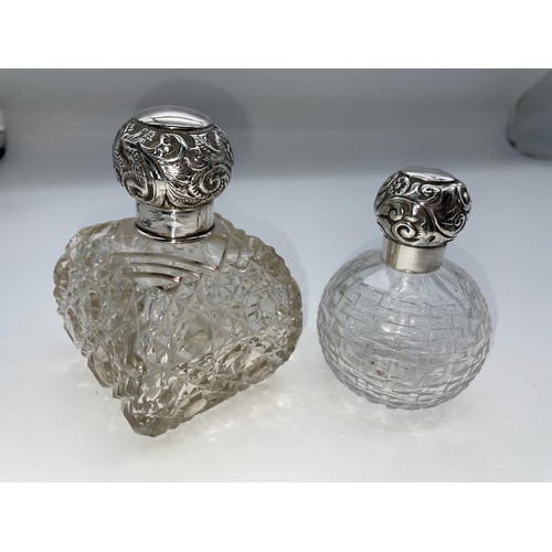 513 - SILVER TOPPED GLOBULAR SCENT BOTTLE AND A SILVER REPOUSE TOPPED BOMBE SHAPED HOBNAIL SCENT BOTTLE