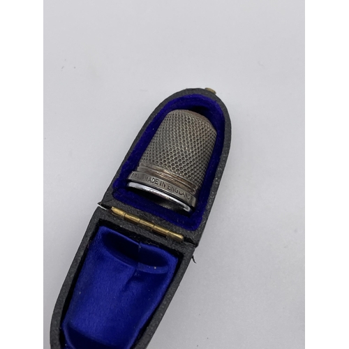 532 - CASED STERLING SILVER THIMBLE AND A SILVER ENGRAVED VESTA CASE