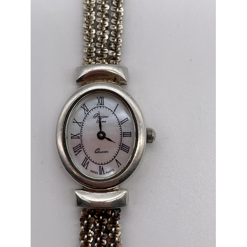 596 - LADIES OVAL FACE QUARTZ WRIST WATCH WITH MOTHER OF PEARL DIAL ON A SILVER THREE STRAND STRAP