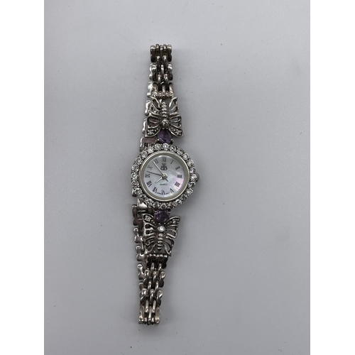 597 - LADIES SILVER QUARTZ CIRCULAR DIAMANTE AND BUTTERFLY STRAP DRESS WATCH