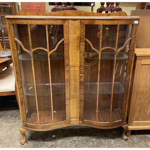 62 - WALNUT SERPENTINE FRONTED GLAZED CABINET height 127cm x width 107cm x depth 32cm approx