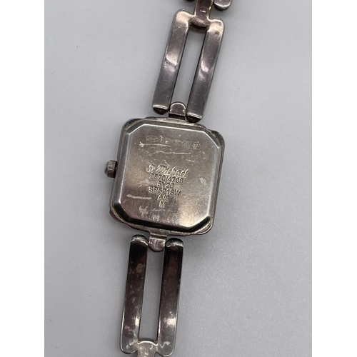 595 - LADIES SQUARE FACED WRIST WATCH ON SILVER OPEN LINK STRAP