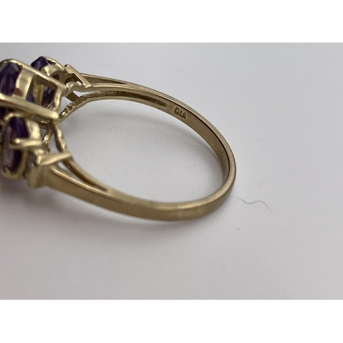 553 - 9CT GOLD STEPPED THREE STONE AMETHYST RING WITH TWIN DIAMOND CHIP SHOULDERS SIZE N 2.6G APPROX