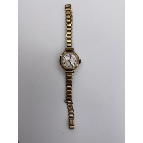 567 - 9CT ROSE GOLD CASED CIRCULAR WRIST WATCH ON A ROLLED GOLD STRAP 13.5G OVERALL