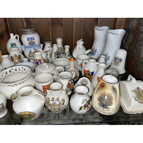 241 - TWO SHELVES OF CRESTED CHINA AND LUCKY HEATHER CERAMICS INCLUDING THE CENOTAPH, BLACKPOOL FERRIS WHE... 