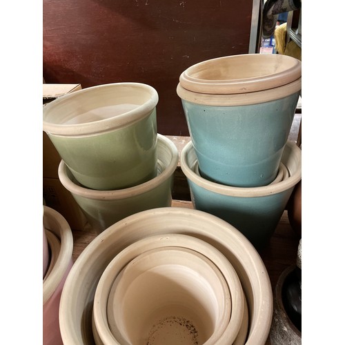 144 - SELECTION OF GRADUATED DEMI GLAZED PLANTERS IN PASTEL SHADES - PINK, AQUA AND OTHERS