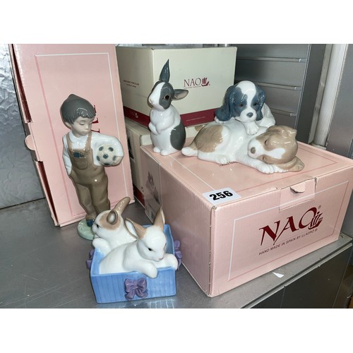 256 - FOUR BOXED NAO PORCELAIN FIGURE GROUPS OF PLAYFUL PUPPIES, RABBITS AND A BOY WITH A FOOTBALL