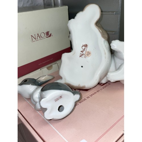 256 - FOUR BOXED NAO PORCELAIN FIGURE GROUPS OF PLAYFUL PUPPIES, RABBITS AND A BOY WITH A FOOTBALL