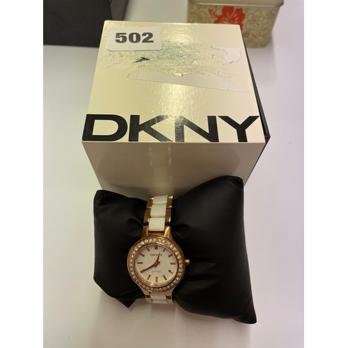 502 - BOXED LADIES DKNY STAINLESS STEEL AND ROSE METAL CERAMIC BRACELET DRESS WATCH WITH PAVE SET BEZEL AN... 