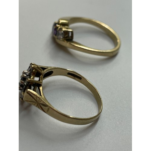 498 - 9CT GOLD AMETHYST AND CZ CROSSOVER RING SIZE N AND A 9CT GOLD SAPPHIRE AND CZ CLUSTER RING SIZE N 6.... 