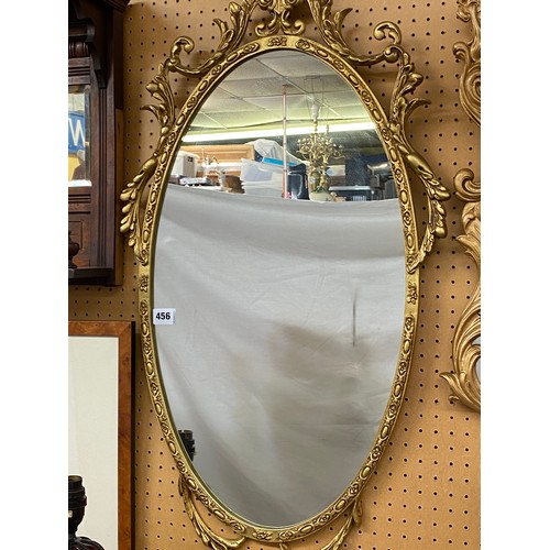 456 - GILT ATHEMIUM SCROLL OVAL MIRROR AND AN ACANTHUS SCROLL FRAMED MIRROR