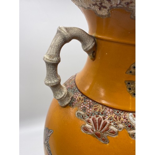 432 - JAPANESE SATSUMA EARTHENWARE TWIN HANDLED VASE DECORATED WITH BUTTERFLIES AND CHRYSANTHEMUMS 47CM H