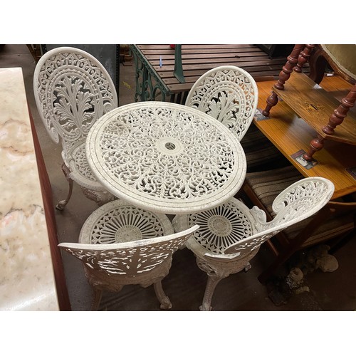 194 - VICTORIAN STYLE WHITE PAINTED WROUGHT IRON PATIO TABLE AND FOUR CHAIRS