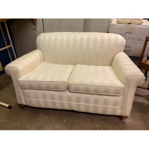 130 - CREAM AND WHITE SATIN STRIPPED TWO SEATER BED SOFA