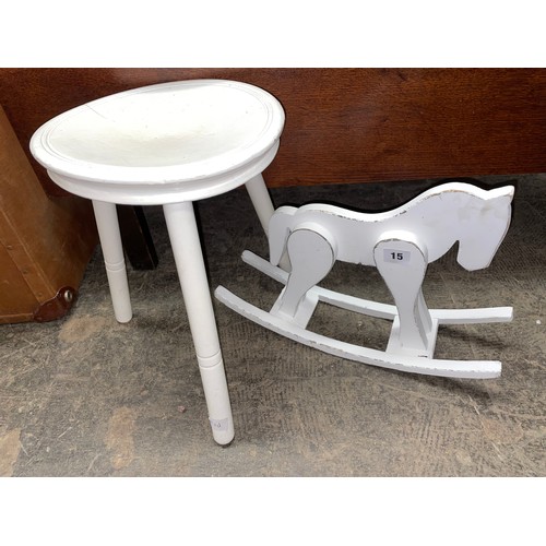 15 - SMALL WHITE PAINTED ROCKING HORSE MODEL AND A THREE LEGGED MILKING STOOL