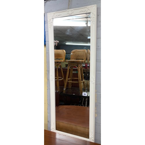 59 - CREAM FLORAL MOULDED AND BEVEL EDGED MIRROR