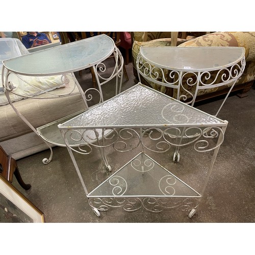126 - PAIR OF DEMILUNE WHITE PAINTED WROUGHT IRON AND GLASS TOPPED GARDEN TABLES AND ONE SIMILAR TRIANGULA... 
