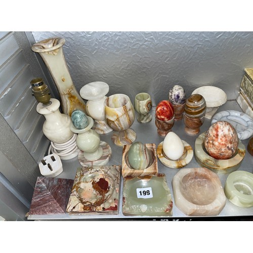 199 - SHELF OF ONYX AND ALABASTER ASHTRAYS, TABLE LIGHTERS, GOBLETS, AND EGGS