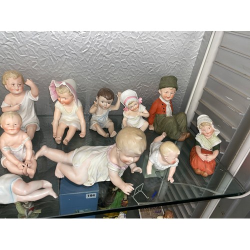 192 - SHELF OF PREDOMINANTLY CONTINENTAL BISQUE PORCELAIN PIANO BABY DOLLS