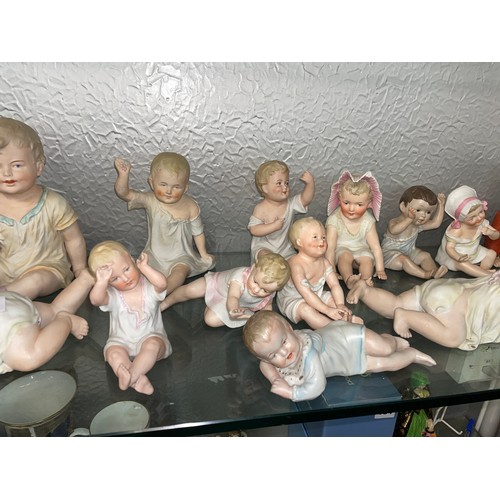 192 - SHELF OF PREDOMINANTLY CONTINENTAL BISQUE PORCELAIN PIANO BABY DOLLS