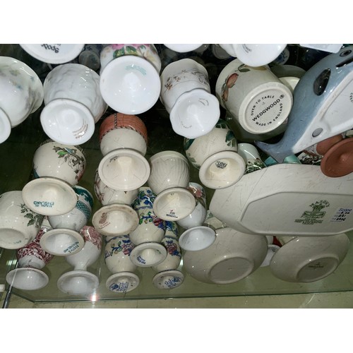 203 - SHELF OF BLUE AND WHITE CORNISH AND WILLOW PATTERN EGG CUPS AND CRUET, MASONS SPODE, POOLE, AND WEDG... 