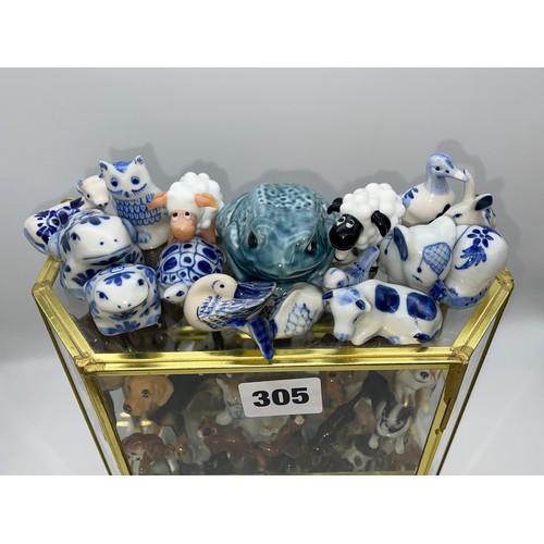 305 - THREE TIER GLAZED CABINET OF CERAMIC MAINLY DOG AND ANIMAL FIGURES