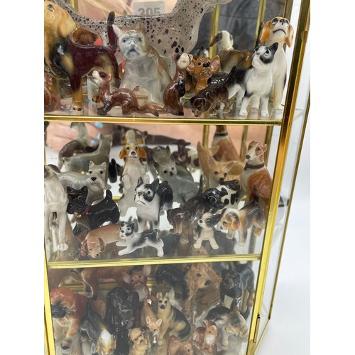 305 - THREE TIER GLAZED CABINET OF CERAMIC MAINLY DOG AND ANIMAL FIGURES