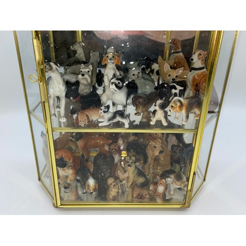 305 - THREE TIER GLAZED CABINET OF CERAMIC MAINLY DOG AND ANIMAL FIGURES