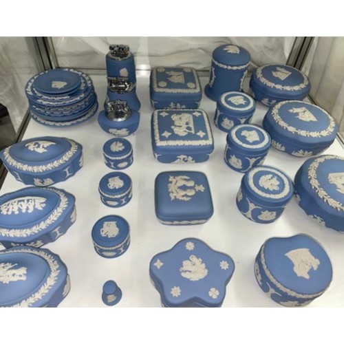 292 - TWO SHELVES OF WEDGWOOD POWDER BLUE JASPERWARE LIGHTERS, LIDDED JARS, SUIT TRAYS, TRINKET DISHES AND... 