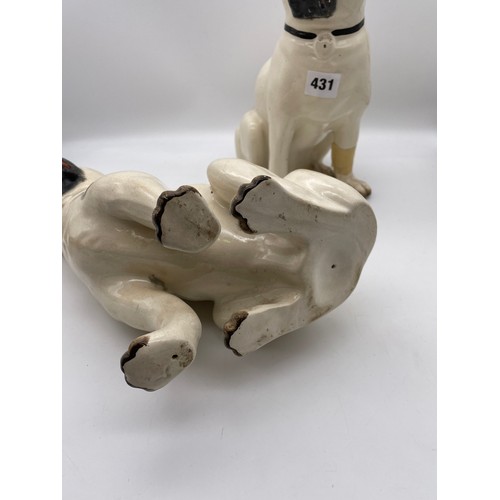 431 - PAIR OF STAFFORDSHIRE POTTERY SEATED PUG DOGS ONE WITH FOOT A/F 27cm