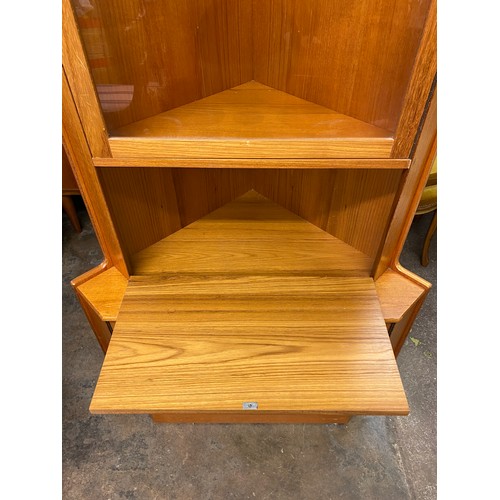 99 - 1960S TEAK TURNIDGE OF LONDON CORNER CABINET WITH DROP TRAY DOOR AND GLASS SHELVES