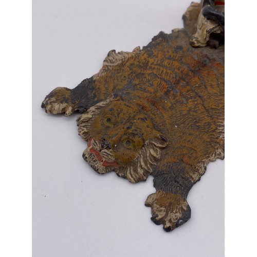 330 - AUSTRIAN COLD PAINTED GROUP OF A SEATED BEDOUIN ON A TIGER SKIN HIDE 5cm x 13cm