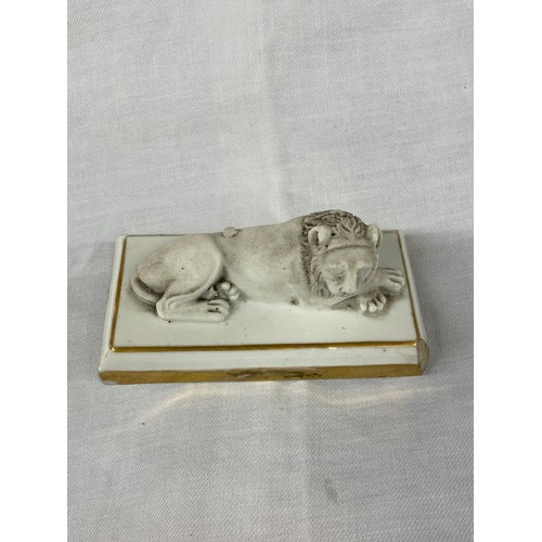 324 - FRENCH DAGOTY PARIS BISCUIT PORCELAIN GILT OUTLINED RECUMBENT LION PAPERWEIGHT, STAMP TO BASE 5cm x ... 