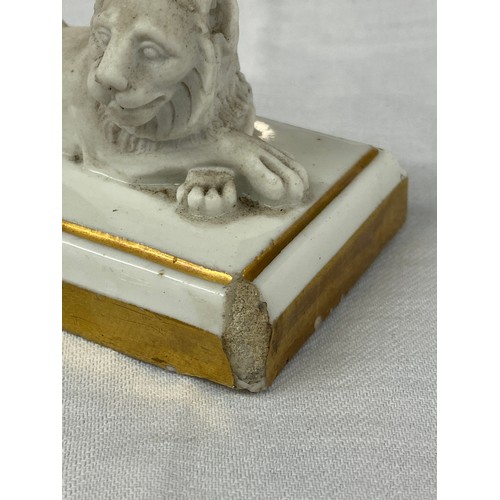 324 - FRENCH DAGOTY PARIS BISCUIT PORCELAIN GILT OUTLINED RECUMBENT LION PAPERWEIGHT, STAMP TO BASE 5cm x ... 