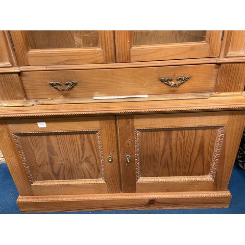 40 - EASTERN EUROPEAN PINE GLAZED CUPBOARD WITH SHELL CRESTED PEDIMENT