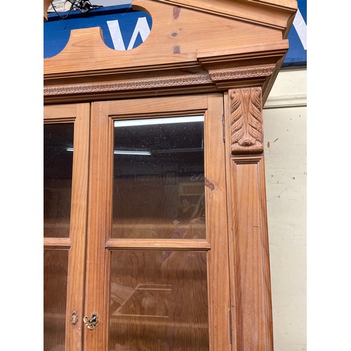 84 - EASTERN EUROPEAN PINE GLAZED CUPBOARD WITH SHELL CRESTED PEDIMENT