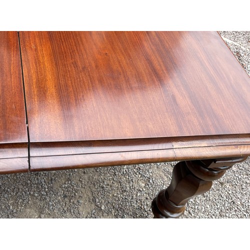 36 - EARLY VICTORIAN FLAME MAHOGANY EXTENDING DINING TABLE WITH MOULDED EDGE ON BULBOUS HEXAGONAL TAPERED... 