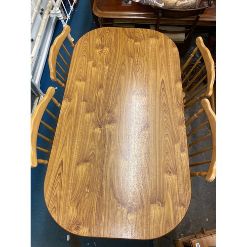 79 - OVAL WOOD EFFECT DINING TABLE AND FOUR CHAIRS