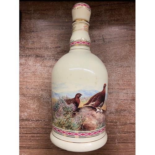 239 - LARGE BOWL OF VARIOUS CARVED WOODEN AND CERAMIC OWL FIGURES, AND PAIR OF FAMOUS GROUSE WHISKEY FLASK... 