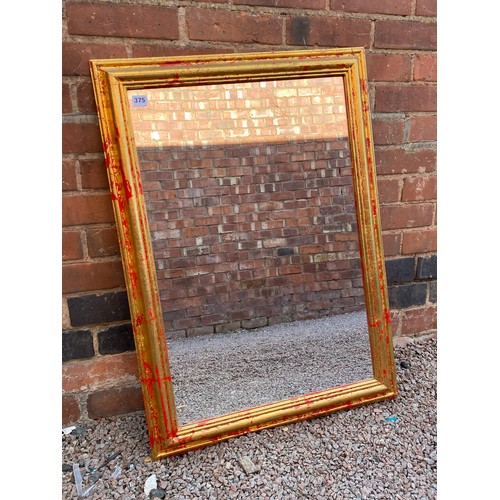 375 - ROLLED CREAM RUG AND A GILT EFFECT MIRROR