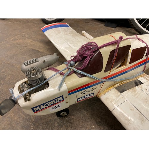 154 - MODEL MAKERS CHEROKEE PLANE, MODEL HELICOPTER, AND BAG OF REMOTE CONTROLLERS