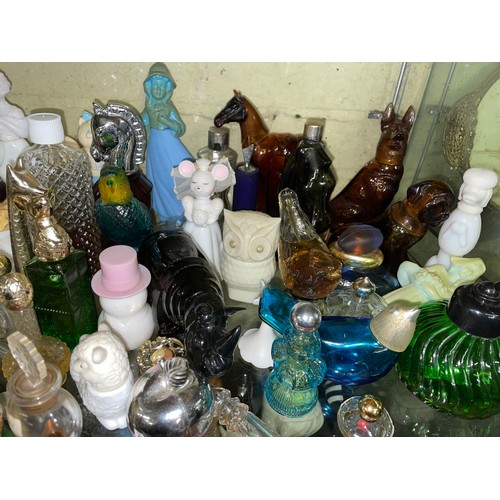 282 - TWO SHELVES OF MAINLY AVON NOVELTY PERFUME AND BATH FOAM BOTTLES AND CONTAINERS