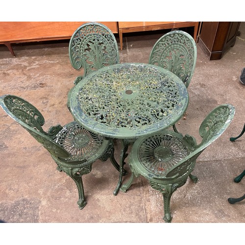 73 - CAST METAL PAINTED VICTORIAN STYLE PATIO TABLE AND FOUR CHAIRS