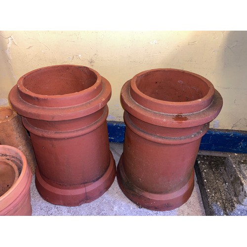 222 - TWO TERRACOTTA CHIMNEY POTS AND FLOWER POTS