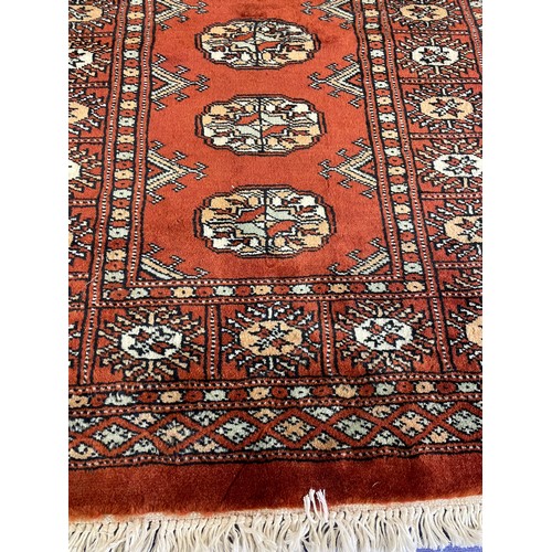 408 - SMALL TERRACOTTA GEOMETRIC PATTERN FRINGED RUG