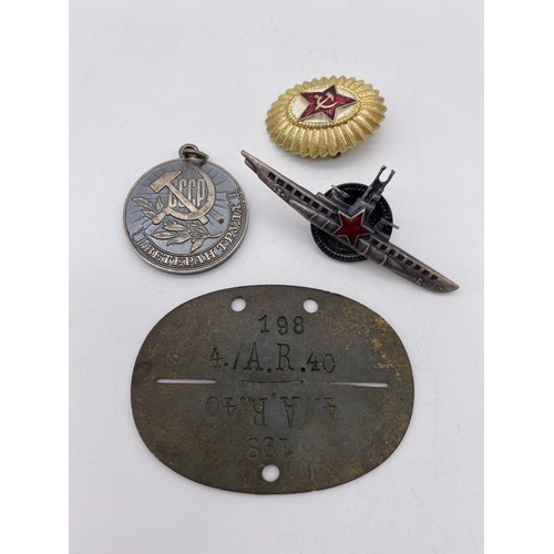 438 - STALINGRAD DEFENCE MEDAL, DOG TAG AND ASSORTED INSIGNIA