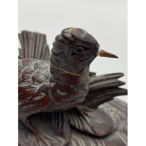 467 - CARVED WOODEN BIRD ON A RAISED MOUNT