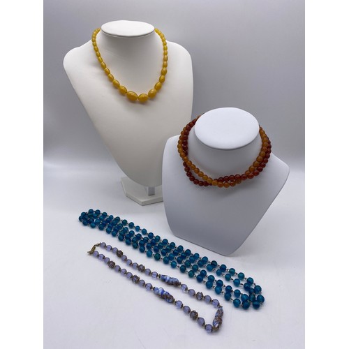 502 - AQUA COLOURED GLASS BALL BEAD NECKLACE, ONE OTHER GLITTER DECORATED STRAND AND AMBER TYPE NECKLACES